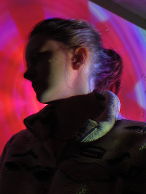 obscured persons face against a colorful background